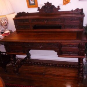 Gothic Revival French oak desk with elaborate carvings on a stretcher base with barley twist legs. Featuring a carved secretaire with five drawers and four to the base France circa 1880.