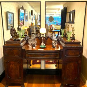 Regency flame mahogany Gentleman's sideboard with applied carvings, fitted interior with hidden door and on sabre feet England circa 1830