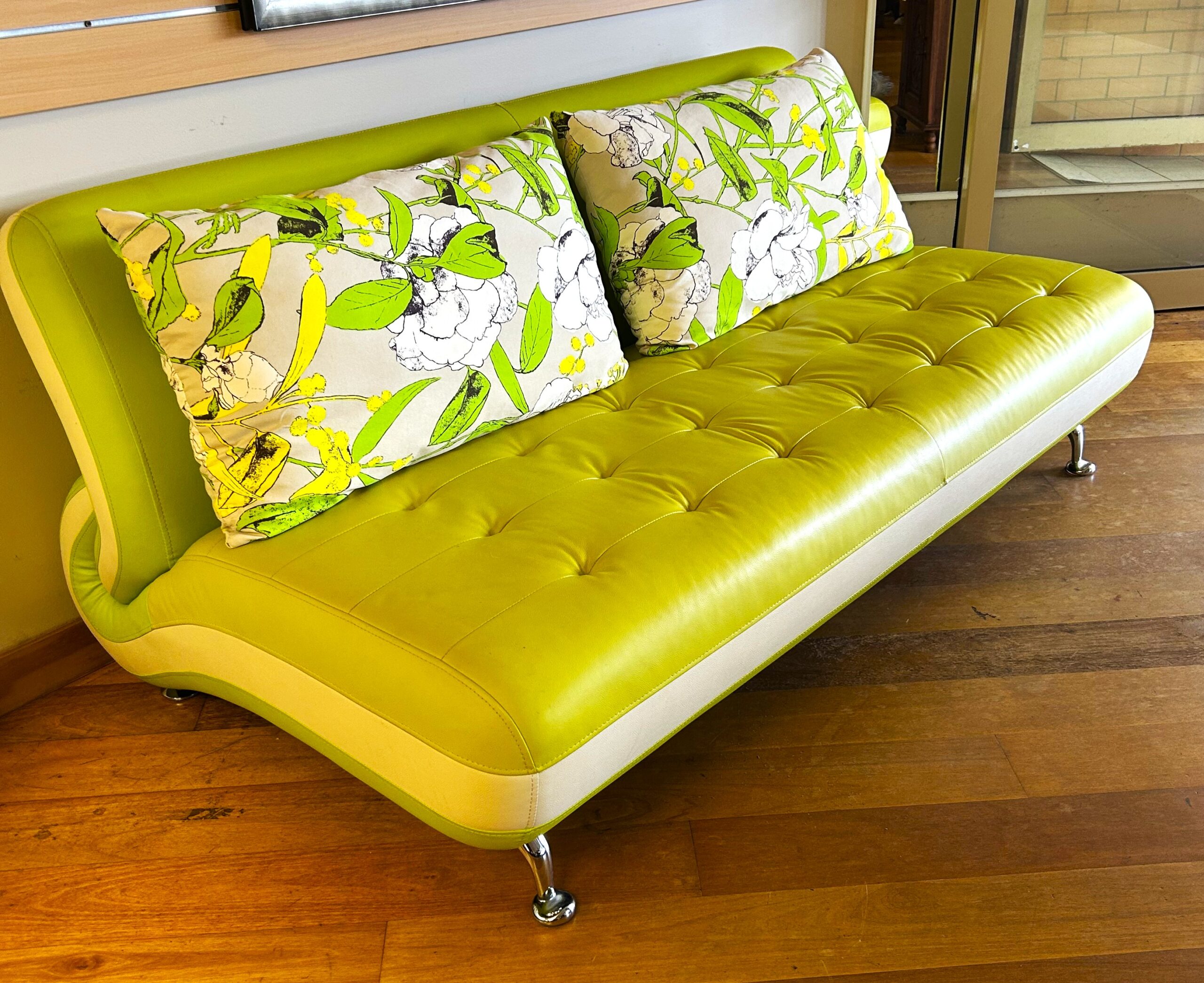 Two tone vinyl two and a half seater sofa with curved features on chrome legs, one replacement rear leg. European (probably Italian) circa 1970