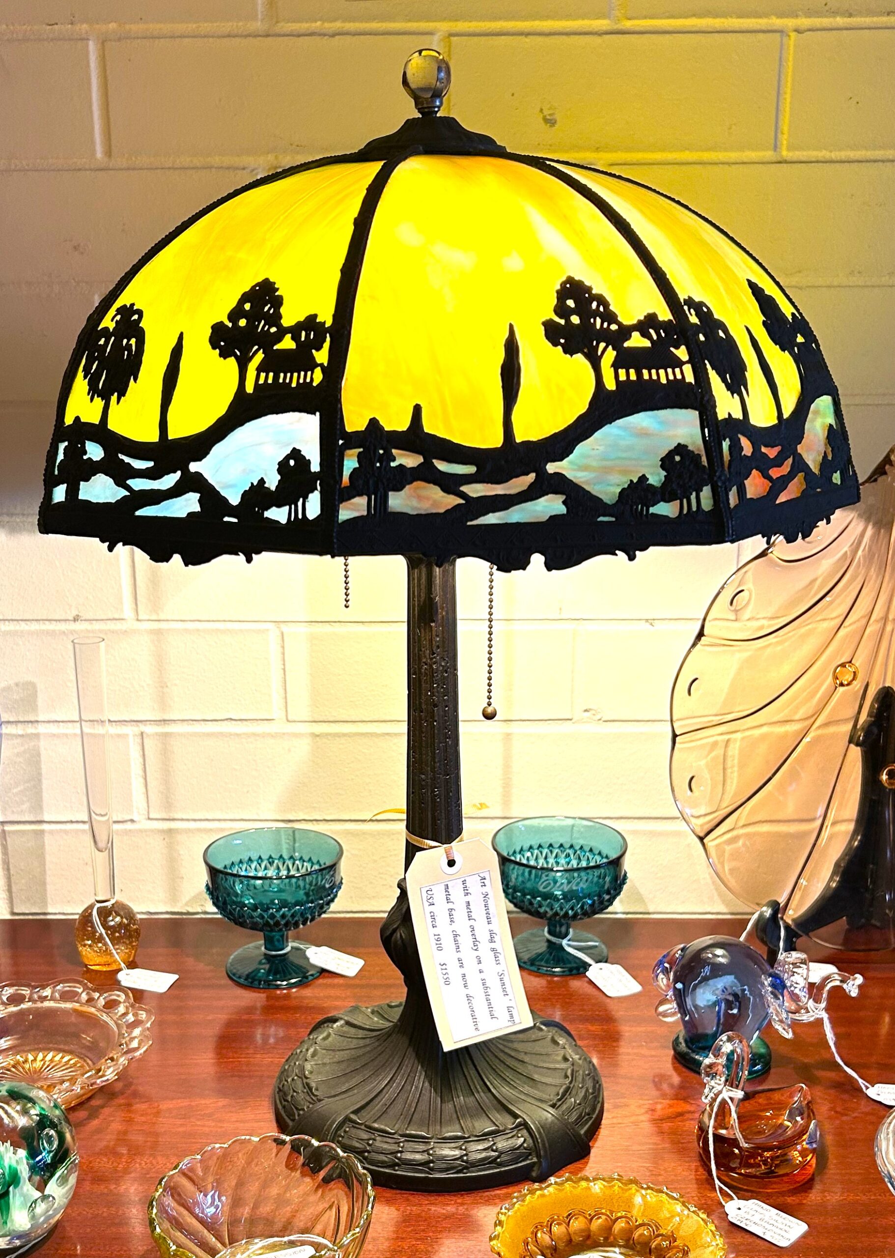 Art Nouveau slag glass ‘Sunset ‘ lamp with metal overlay on a substantial metal base, chains are now decorative USA circa 1910